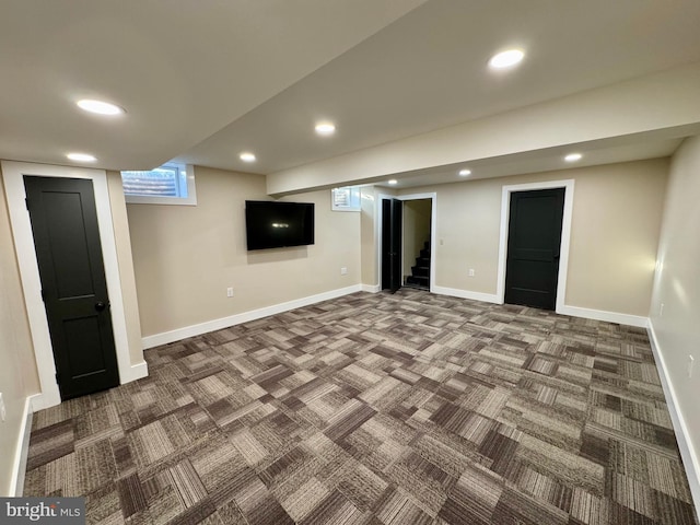 below grade area with stairway, recessed lighting, carpet flooring, and baseboards