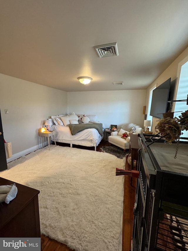 carpeted bedroom featuring visible vents and baseboards