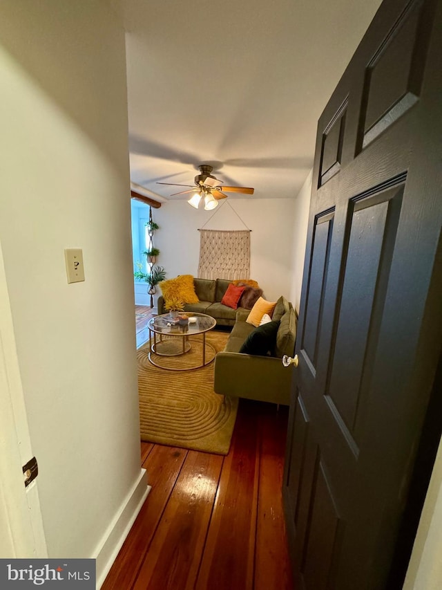 hallway with hardwood / wood-style flooring and baseboards