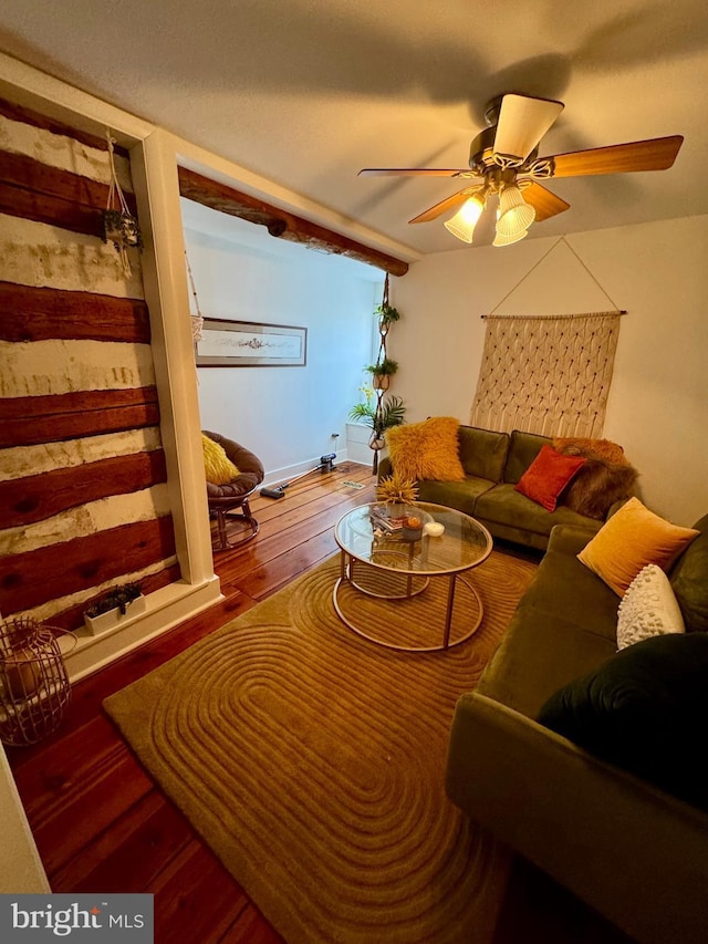 living area featuring a ceiling fan and hardwood / wood-style flooring