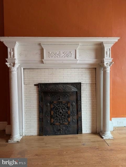 details with a fireplace and wood finished floors