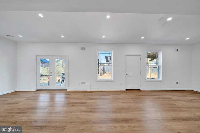 interior space featuring recessed lighting, french doors, plenty of natural light, and light wood finished floors