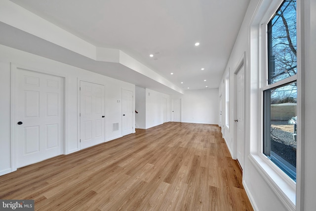 interior space with recessed lighting, visible vents, light wood-style flooring, and baseboards