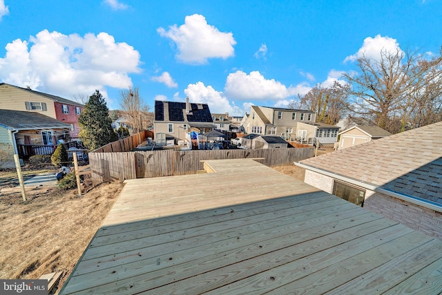 wooden deck with a fenced backyard and a residential view