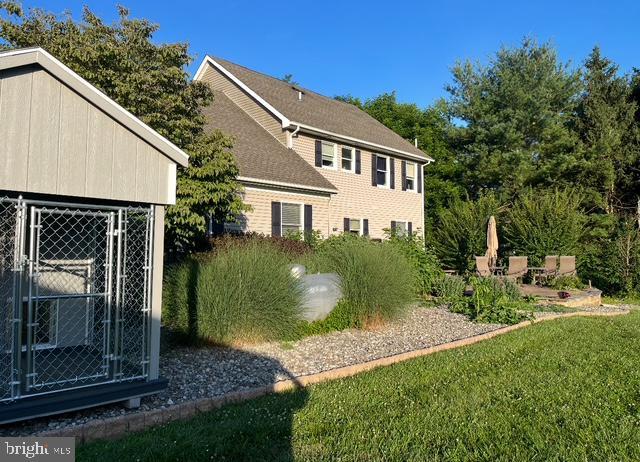 view of home's exterior with an exterior structure and an outbuilding