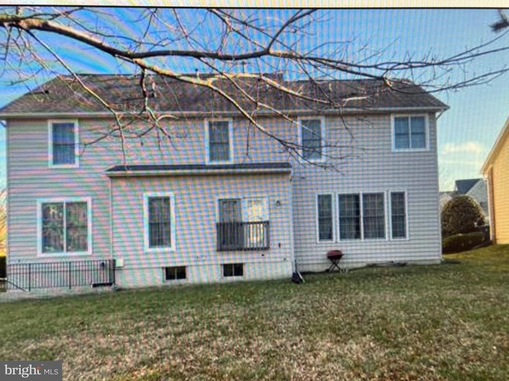back of house with a yard