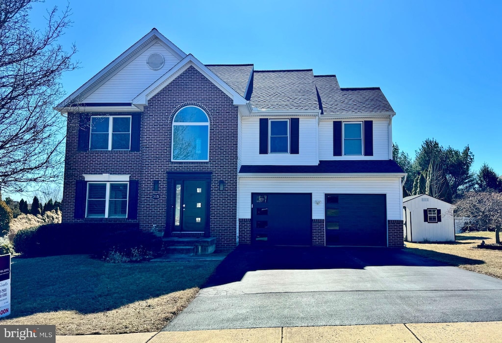 view of front of property with a garage, brick siding, and driveway