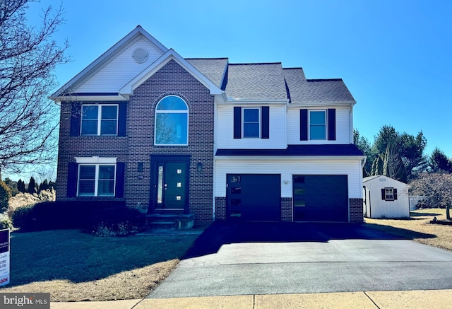 view of front of property with a garage, brick siding, and driveway