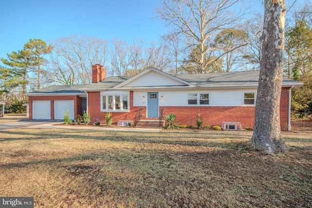 ranch-style house with an attached garage, a chimney, a front lawn, and brick siding