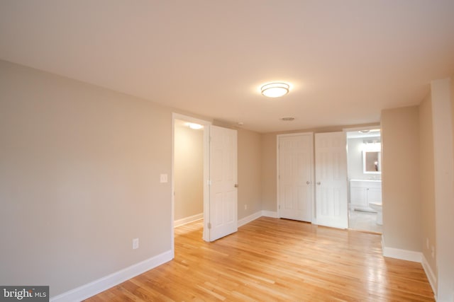 interior space with light wood-style floors and baseboards