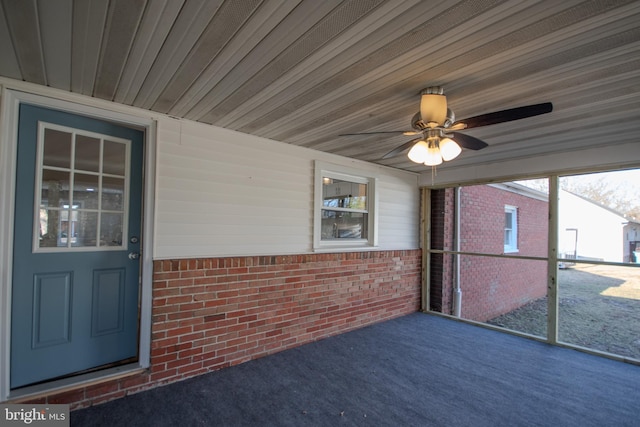 unfurnished sunroom featuring ceiling fan and wooden ceiling