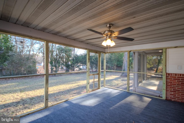 unfurnished sunroom with a ceiling fan