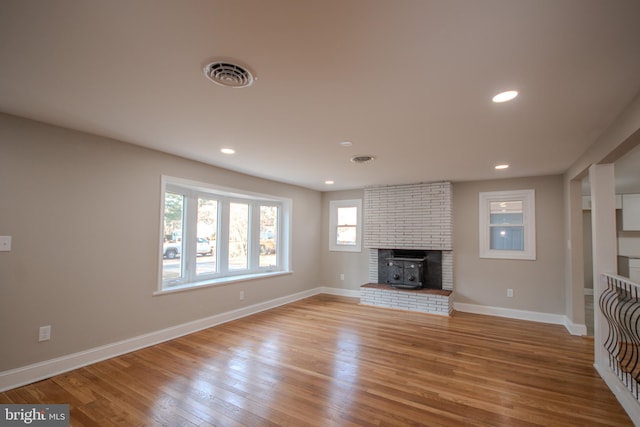 unfurnished living room with recessed lighting, wood finished floors, visible vents, and baseboards