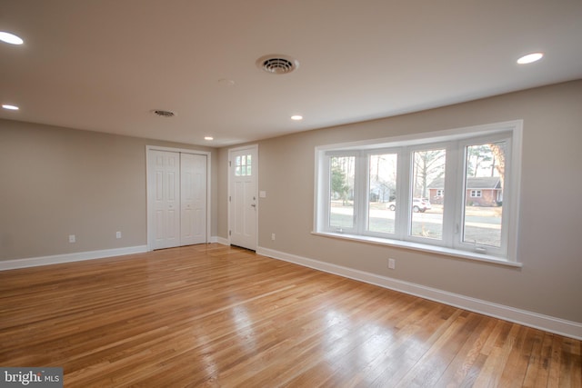 interior space with light wood-style floors, recessed lighting, visible vents, and baseboards