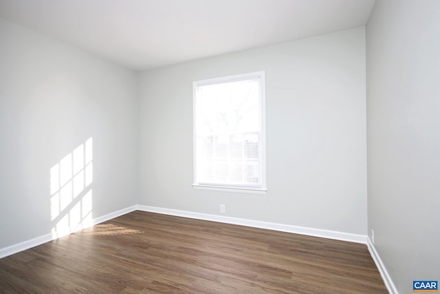 unfurnished room featuring dark wood finished floors and baseboards