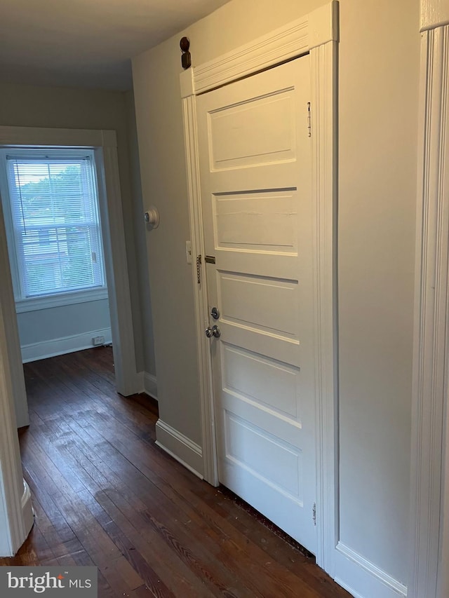 interior space with dark wood-style floors and baseboards