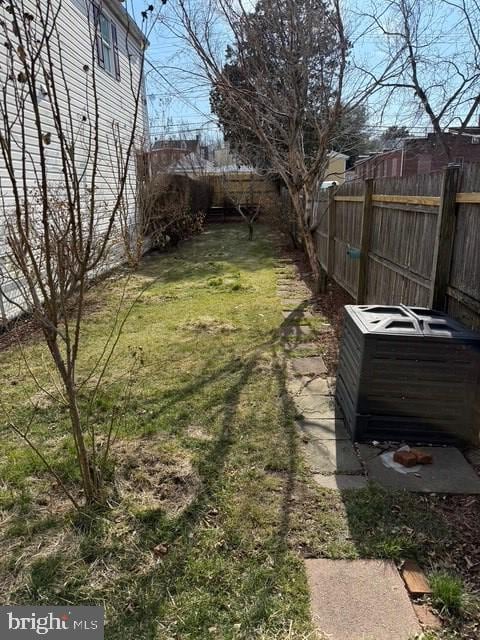 view of yard with a fenced backyard and a jacuzzi