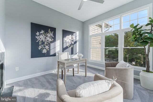 carpeted office featuring baseboards and ceiling fan
