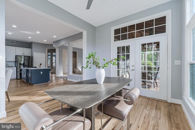 dining area with visible vents, baseboards, ceiling fan, french doors, and light wood finished floors