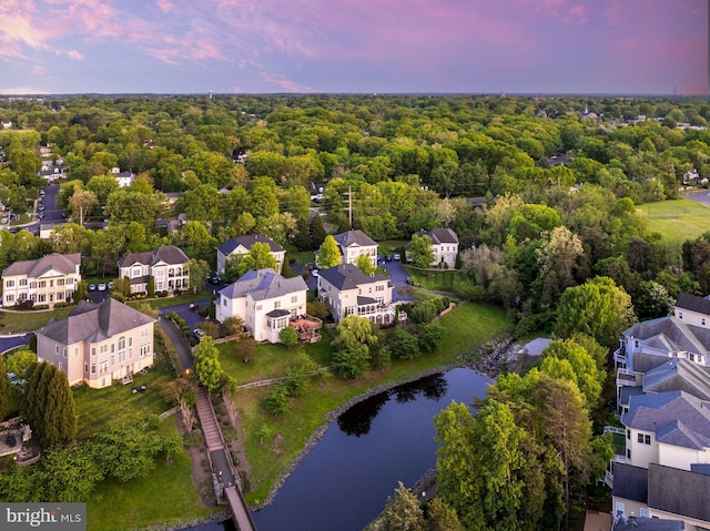 drone / aerial view with a water view and a residential view