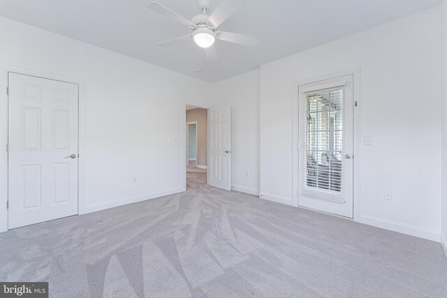spare room featuring baseboards, ceiling fan, and carpet flooring