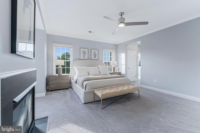 bedroom with crown molding, baseboards, visible vents, and carpet