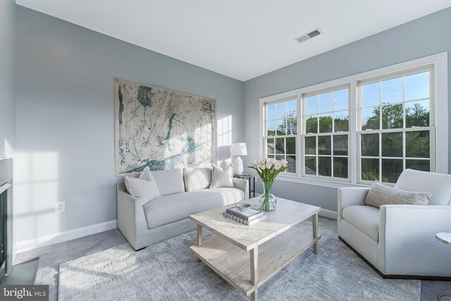 living room with baseboards and visible vents