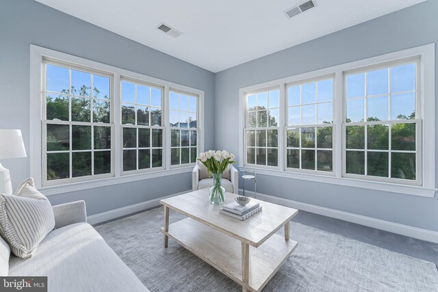 living room with baseboards and visible vents
