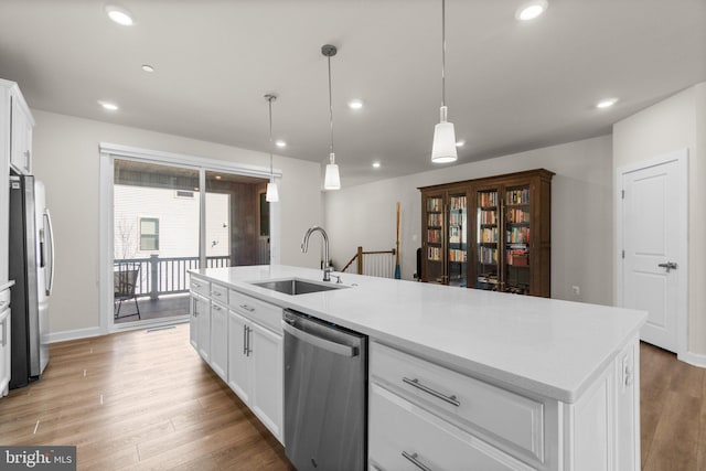 kitchen featuring a sink, recessed lighting, stainless steel appliances, white cabinets, and light wood finished floors