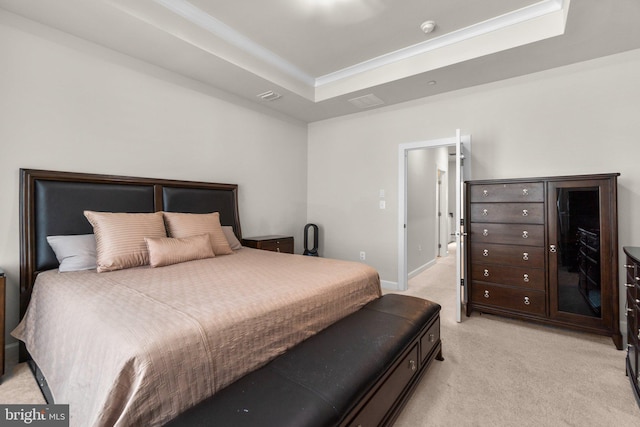 bedroom with light carpet, a raised ceiling, and baseboards