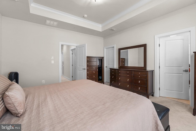 bedroom with visible vents, a raised ceiling, and carpet flooring