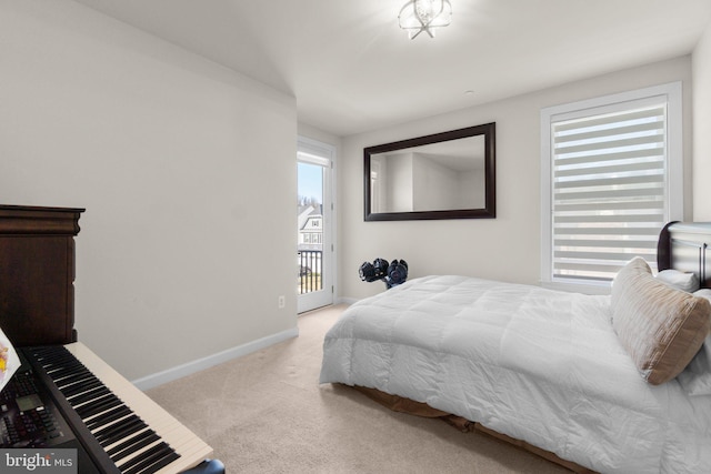 bedroom with access to outside, baseboards, and carpet floors