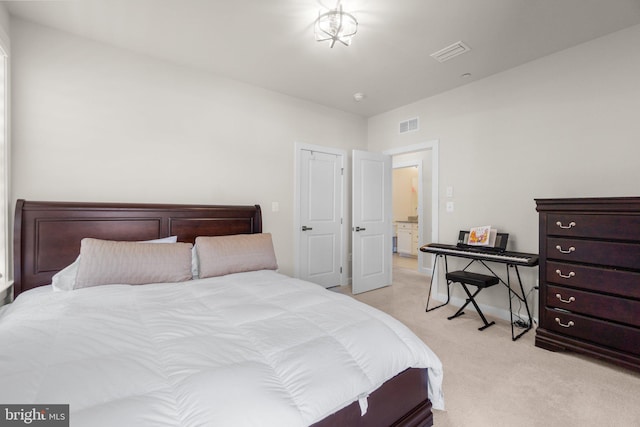 bedroom featuring visible vents and light carpet