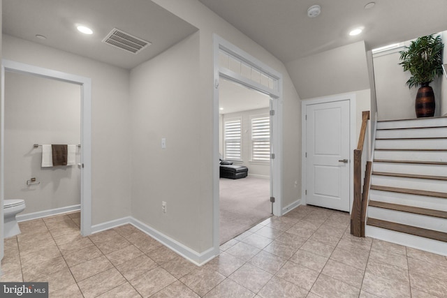 foyer entrance featuring visible vents, recessed lighting, light tile patterned floors, baseboards, and stairs