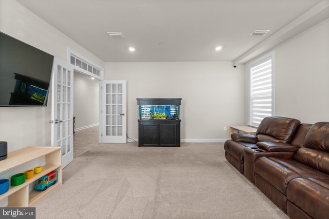 living room featuring visible vents, baseboards, recessed lighting, french doors, and carpet flooring