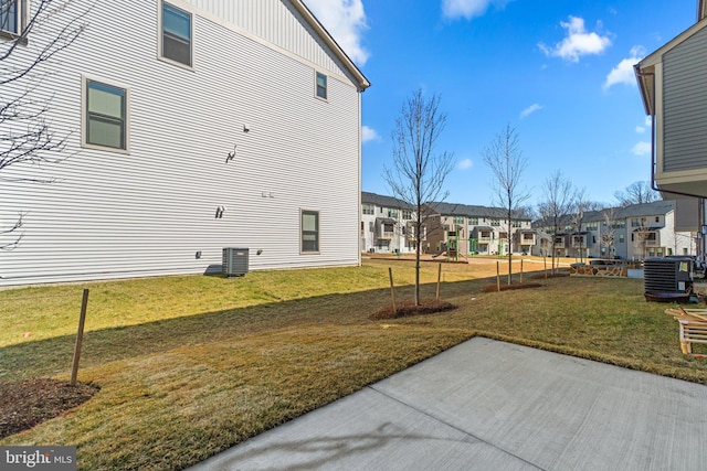 view of yard featuring a patio area, a residential view, and cooling unit