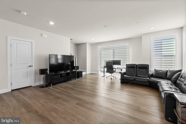 living room with recessed lighting, baseboards, and wood finished floors