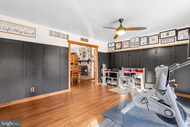 home office with wood finished floors, visible vents, and a ceiling fan