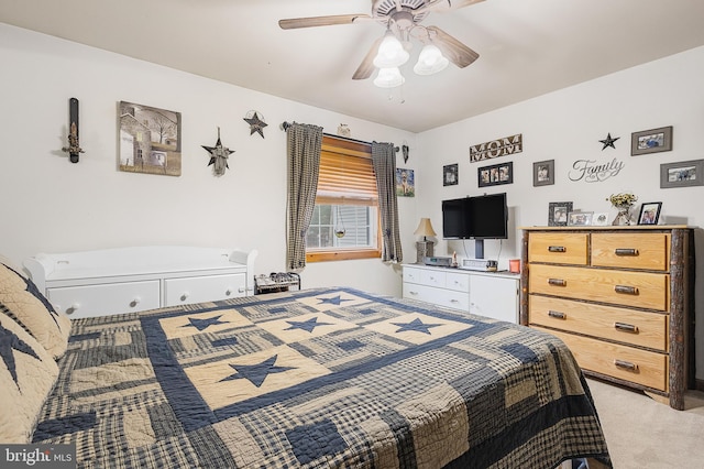 bedroom with a ceiling fan and light colored carpet