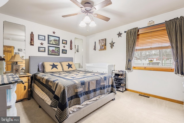 bedroom with a ceiling fan, carpet, visible vents, and baseboards