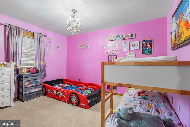 bedroom featuring carpet flooring and a notable chandelier