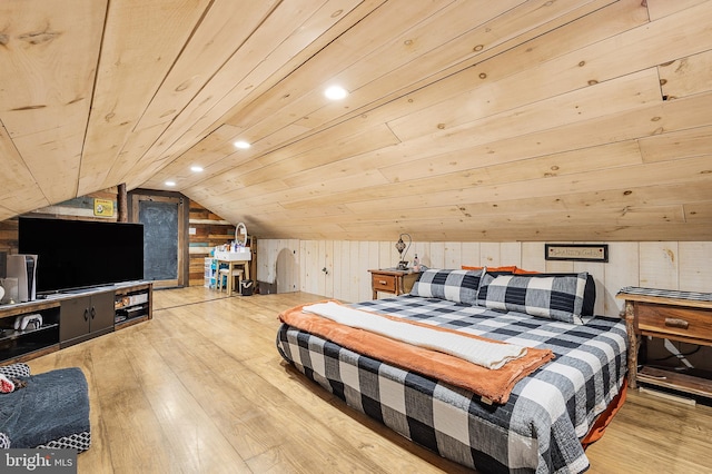 bedroom featuring wooden ceiling, vaulted ceiling, wooden walls, and wood finished floors