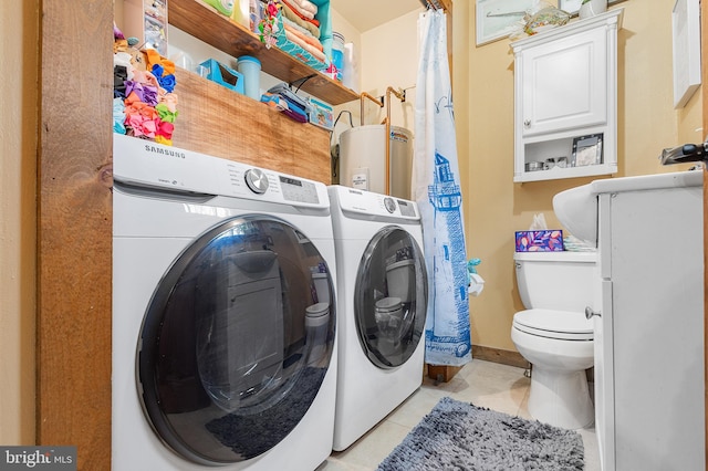 laundry room featuring light tile patterned floors, laundry area, separate washer and dryer, and water heater