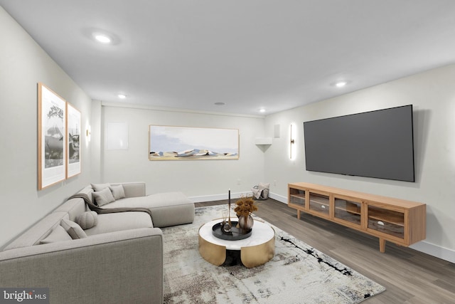 living area with recessed lighting, wood finished floors, and baseboards