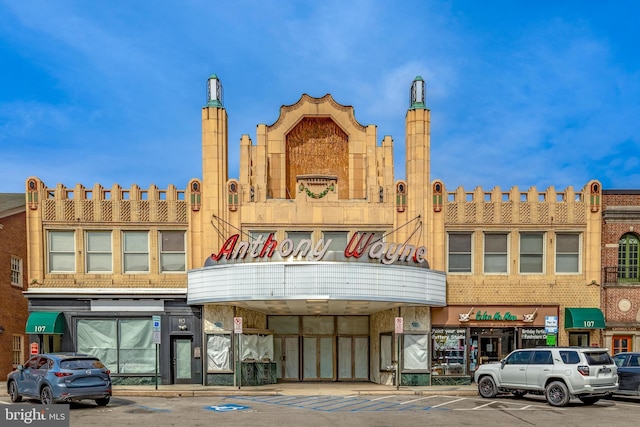 view of building exterior featuring uncovered parking