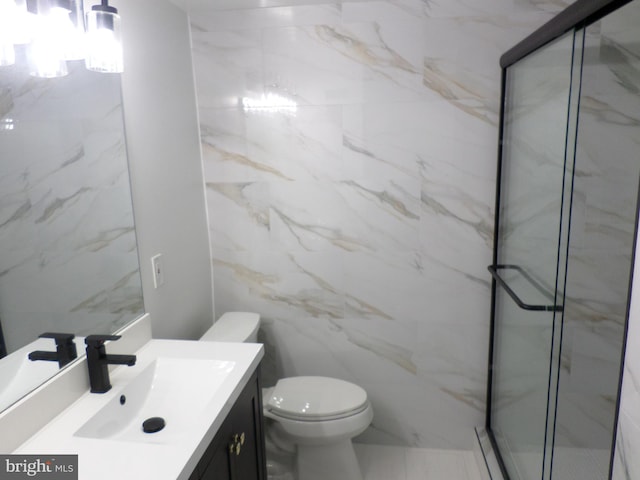 bathroom with toilet, a marble finish shower, tile walls, and vanity