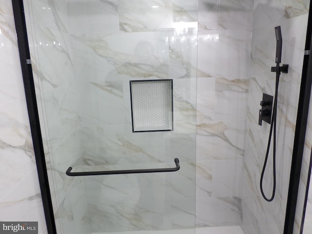 full bath featuring a marble finish shower