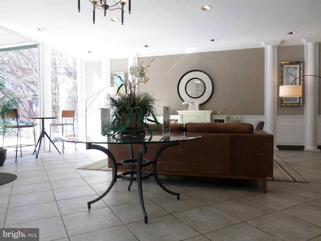 tiled living room featuring wallpapered walls, decorative columns, crown molding, floor to ceiling windows, and recessed lighting