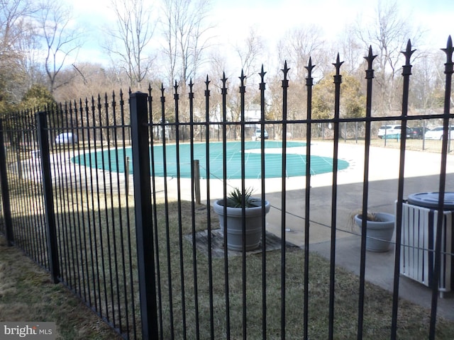 community pool featuring fence and central AC