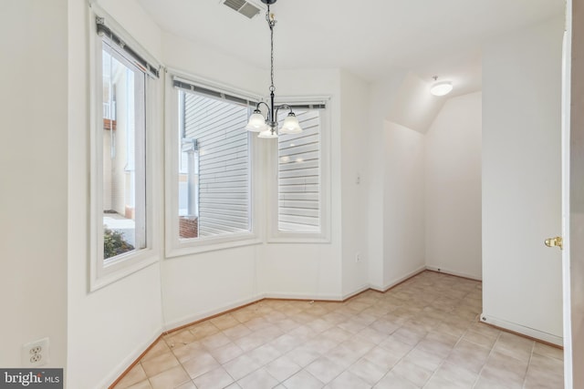 unfurnished dining area with visible vents, baseboards, a healthy amount of sunlight, and a chandelier